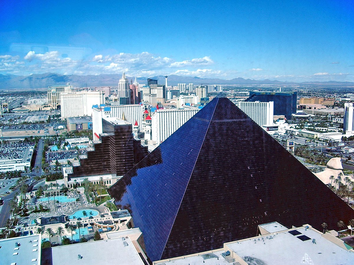 Exterior night view of Luxor Las Vegas with its iconic pyramid illuminated. 